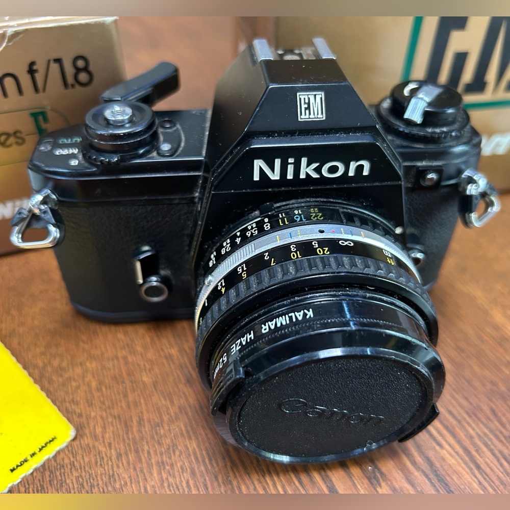 Vintage Nikon Black EM Film Camera w 50mmf/1.8 lens series E. Replaced lenscover